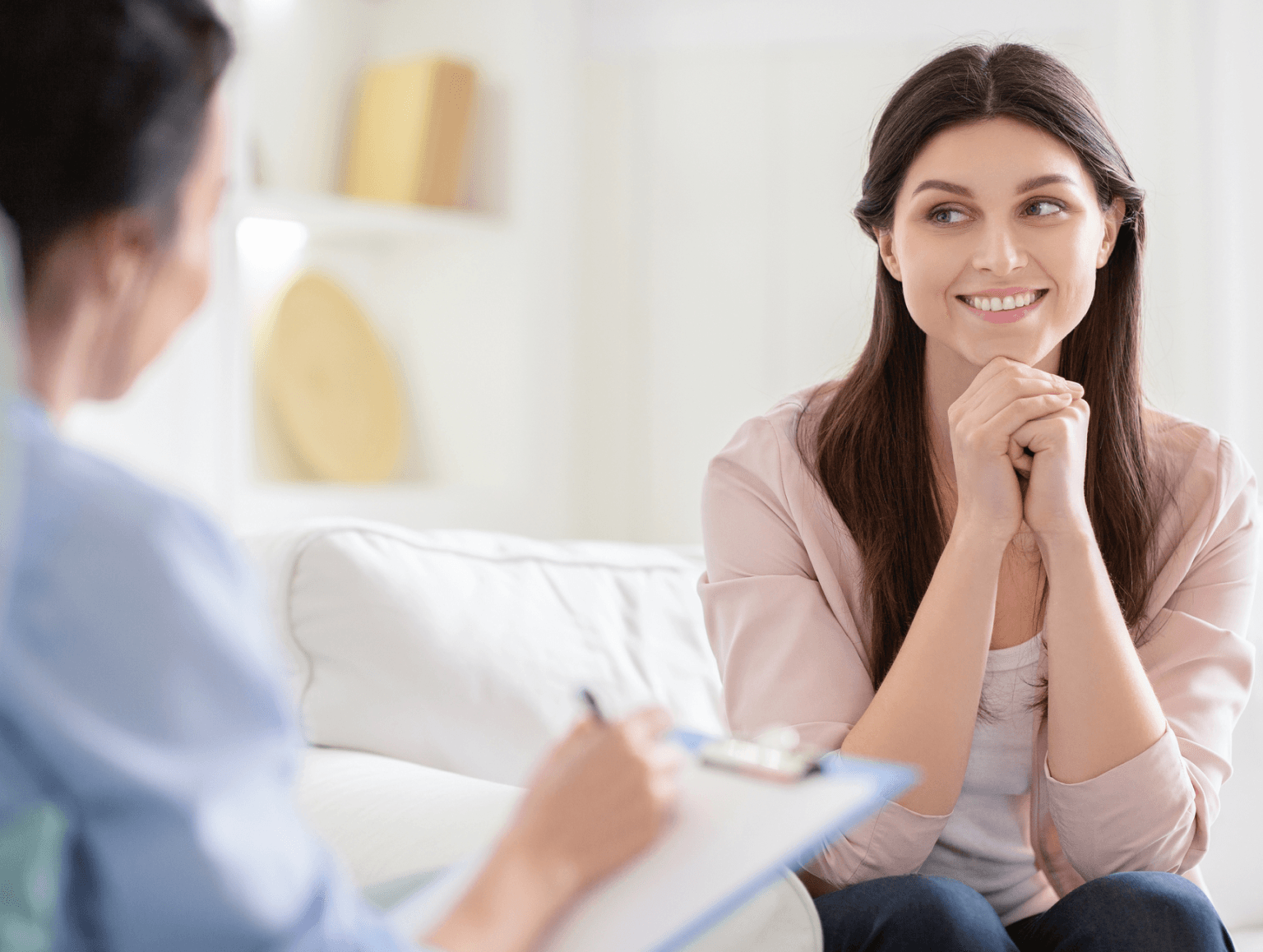 Smiling woman talking to health coach about motivation