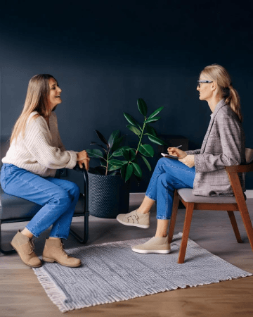 Smiling woman talking to health coach about motivation