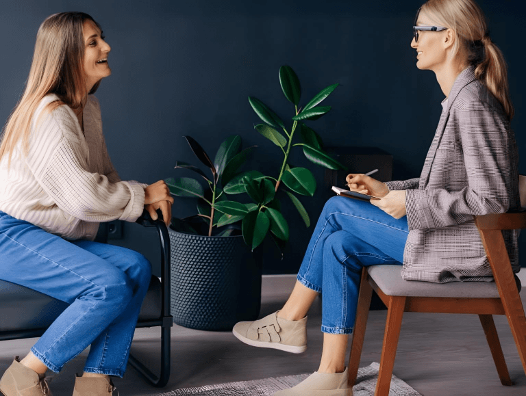 Smiling woman talking to health coach about motivation